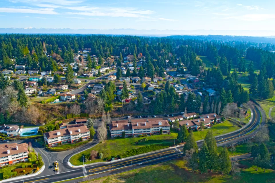 Aerial view of Edmonds, Washington with road in foreground and buidings surrounded by trees